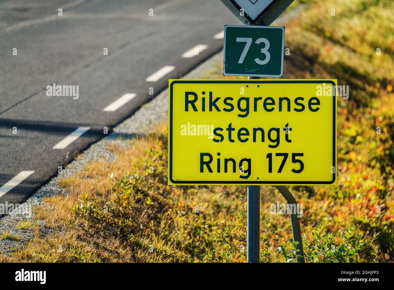 'State border is closed' is written on Norwegian on road sign checkpoint between Sweden and Norway. Corona restrictions stops travel over certain chec Stock Photo