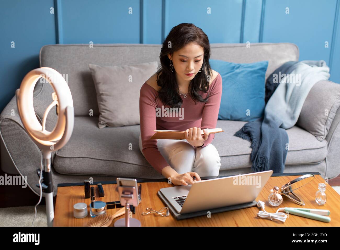 Young woman using laptop at home Stock Photo