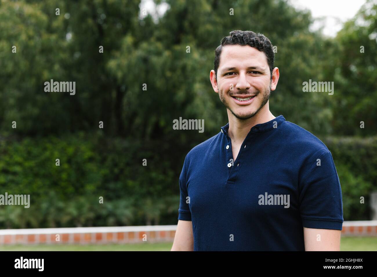 portrait of young Hispanic man at the park in latin america Stock Photo