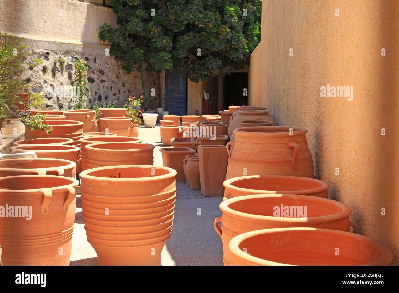 Terracotta plant pots in the traditional village of Megalochori in Santorini, Greece Stock Photo