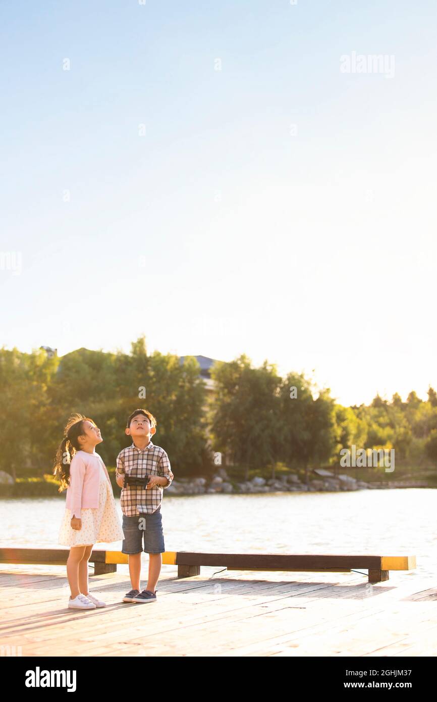 Happy children playing with remote control toy Stock Photo Alamy