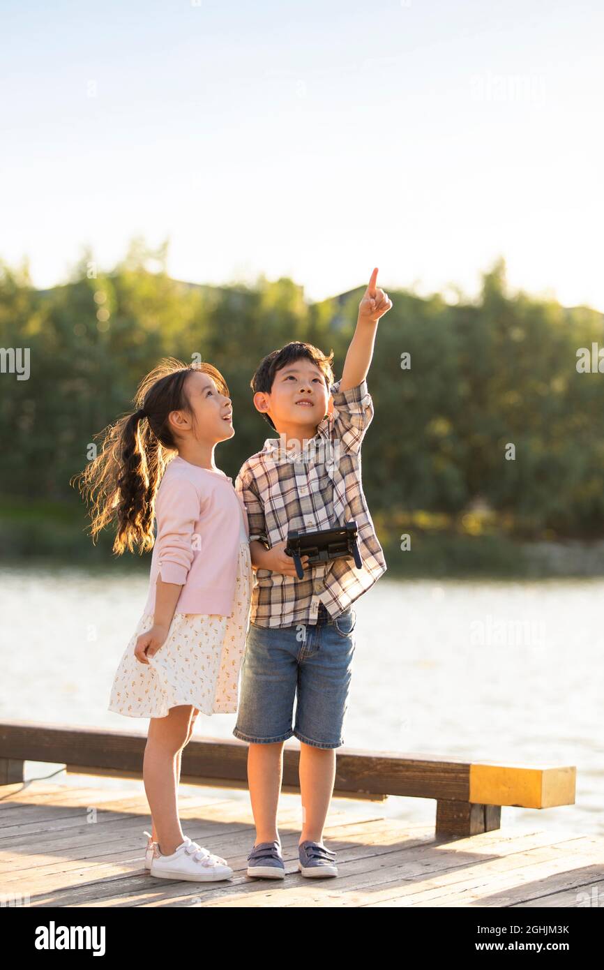 Happy children playing with remote control toy Stock Photo Alamy