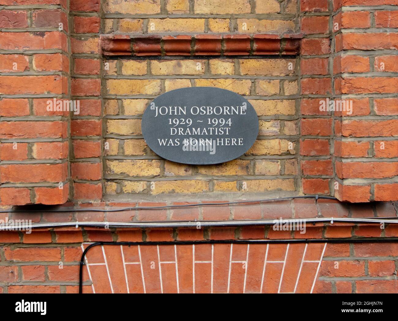 Plaque on wall of the house where John Osborne, playwright and actor