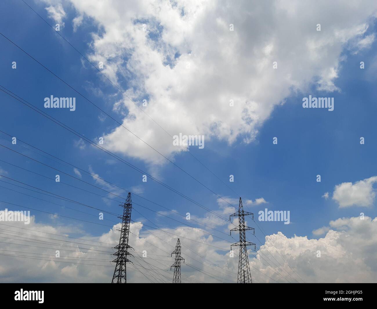 electric towers on the horizon on a bright sunny day Stock Photo