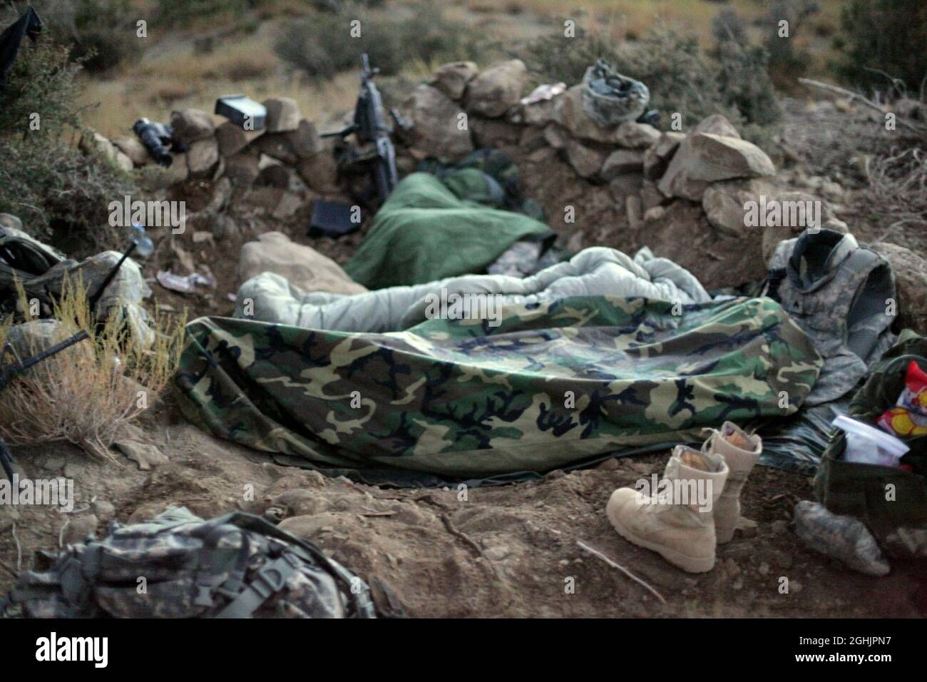 U.S. Army Soldiers sleep in a hasty fighting position on a cold morning in the mountains near Sar Howza, Paktika province, Afghanistan, Sept. 4. The Soldiers are deployed with Bulldog Troop, 1st Squadron, 40th Cavalry Regiment. Stock Photo