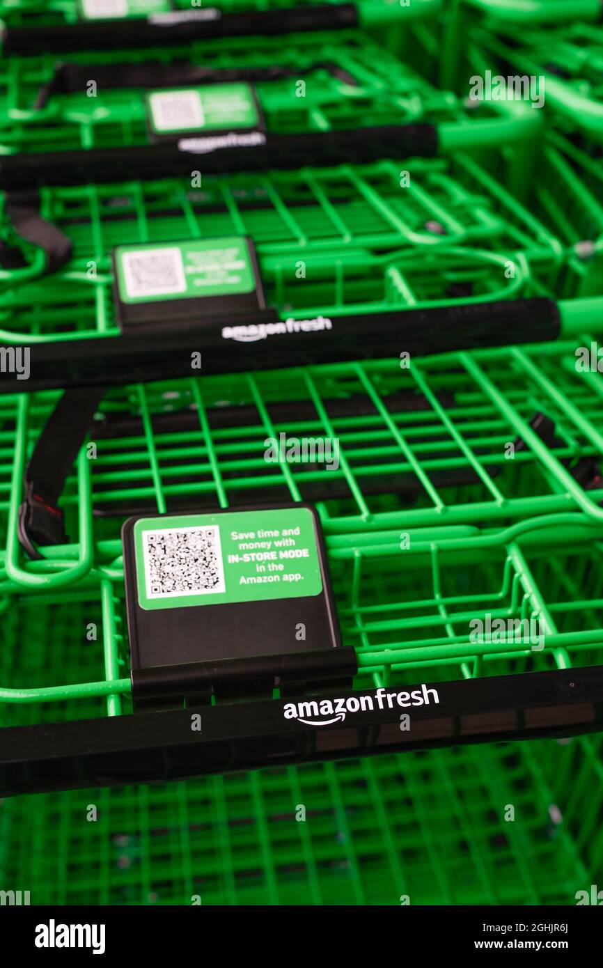 Factoria, WA, USA - September 06, 2021; Green grocery carts close up outside the Amazon Fresh location in Factoria Washington Stock Photo