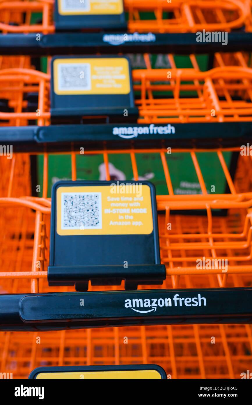 Factoria, WA, USA - September 06, 2021; Orange grocery carts close up outside the Amazon Fresh location in Factoria Washington Stock Photo