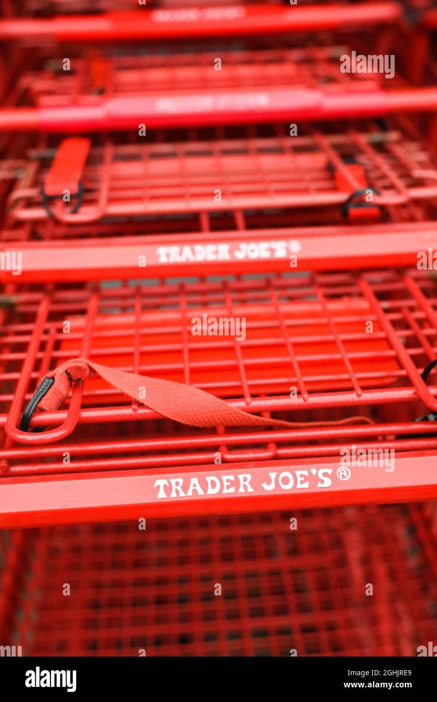 Issaquah, WA, USA - September 06, 2021; Red Trader Joe's shopping carts with red writing at the company store in Issaquah Washington Stock Photo