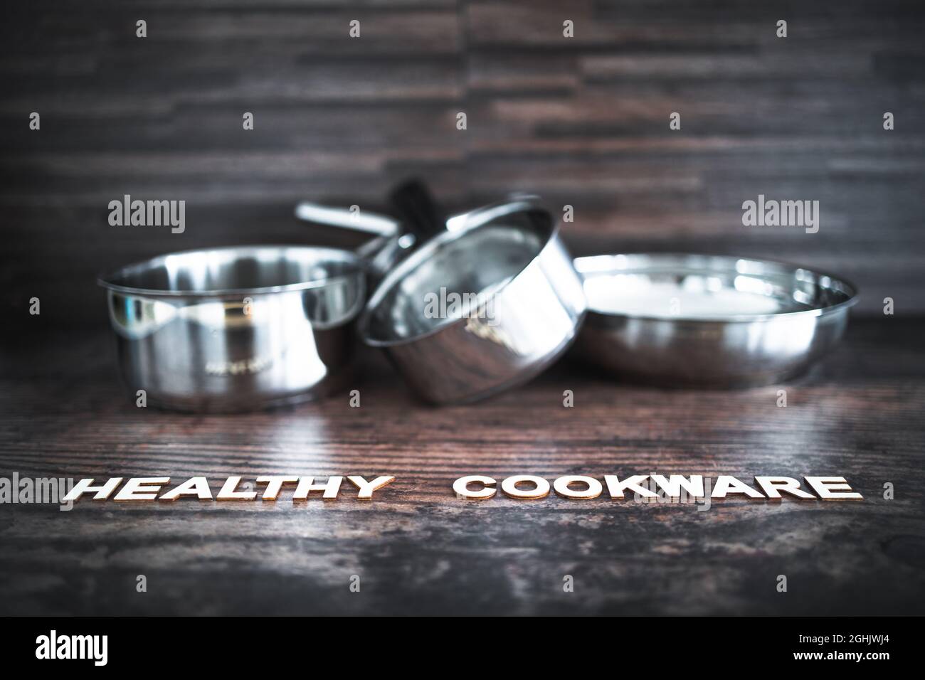 healthy cooking and harsh chemicals concept, stainless steel pots and