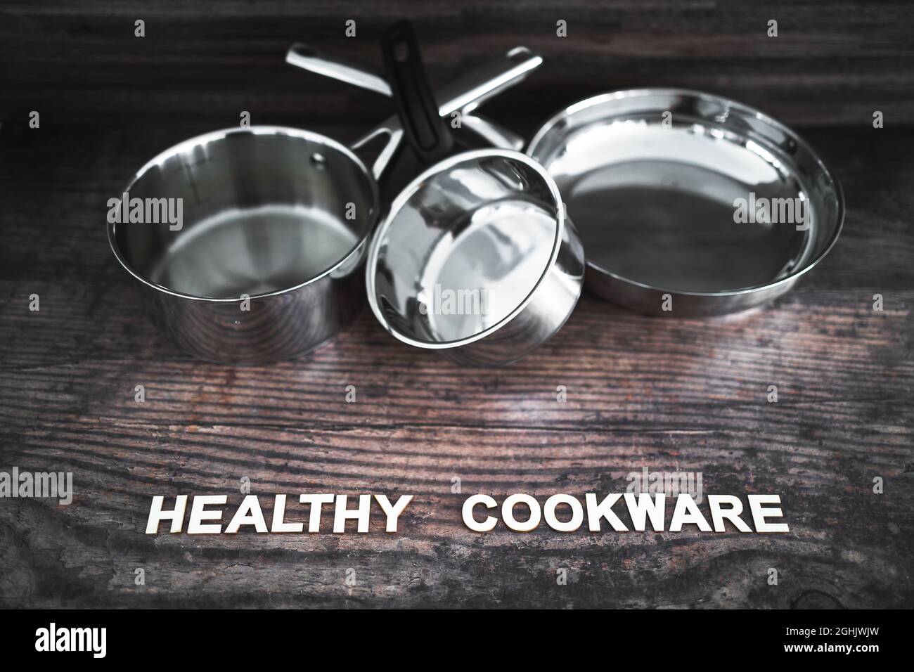 healthy cooking and harsh chemicals concept, stainless steel pots and
