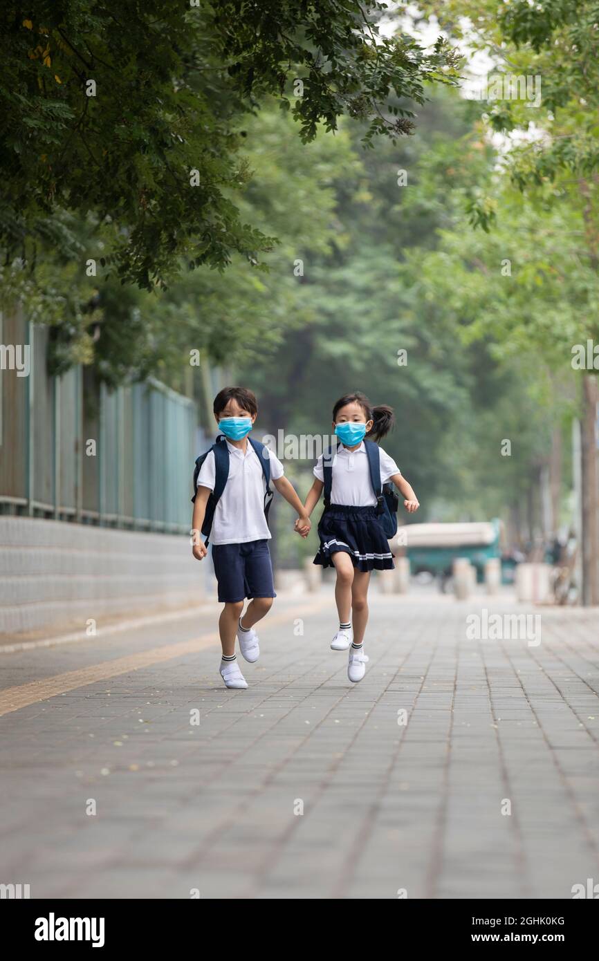 Two girls wearing school uniform hi-res stock photography and images ...