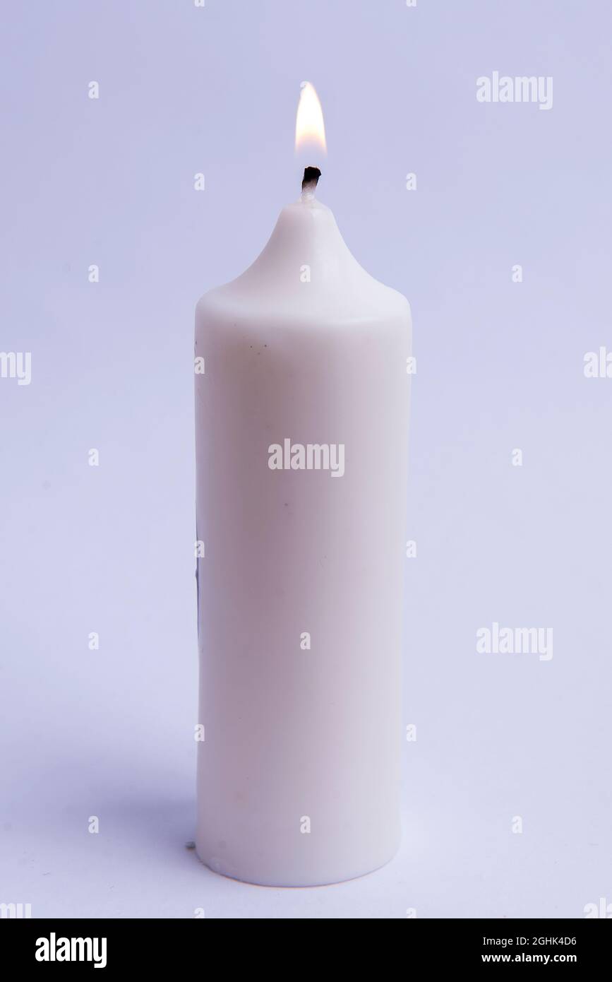 Burning candle with white background Stock Photo - Alamy