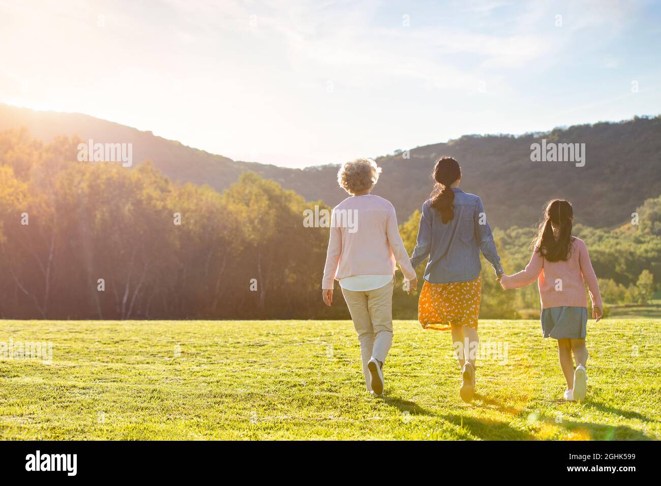 Happy family relaxing on meadow Stock Photo