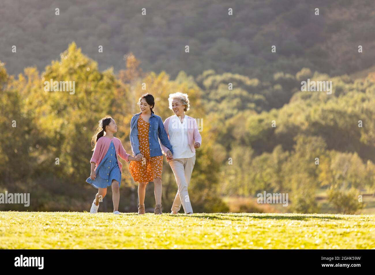 Happy family relaxing on meadow Stock Photo