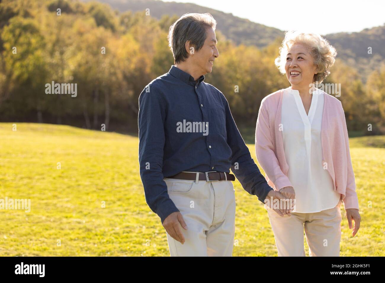 Chinese couple walking holding hi-res stock photography and images - Alamy
