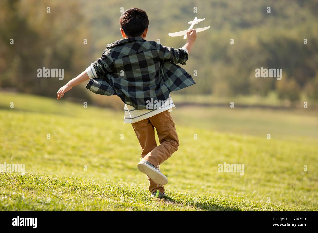 Happy boy playing on meadow Stock Photo