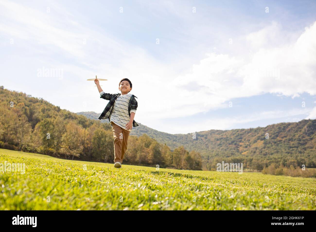 Happy boy playing on meadow Stock Photo
