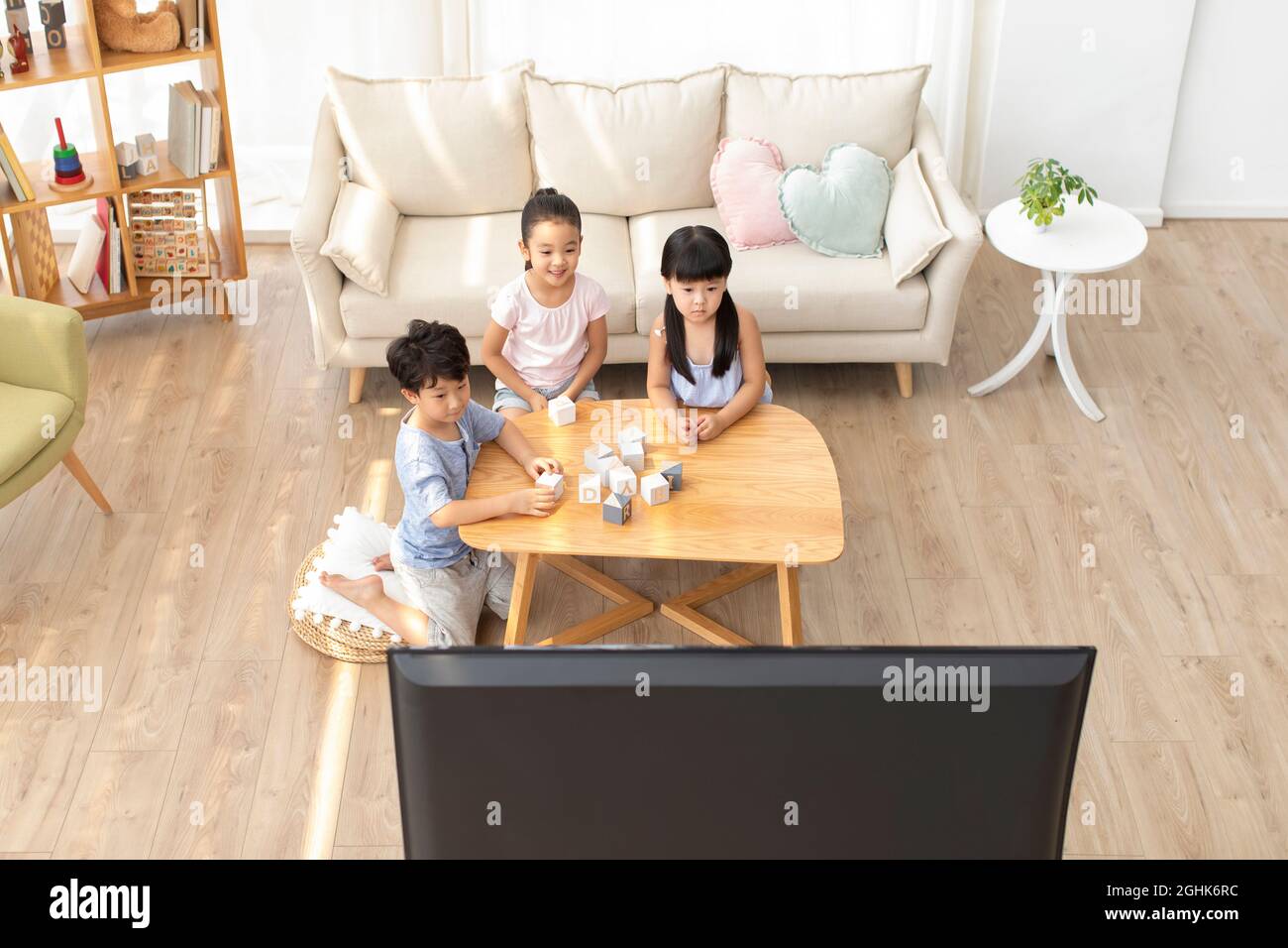 Cute children watching TV in living room Stock Photo - Alamy