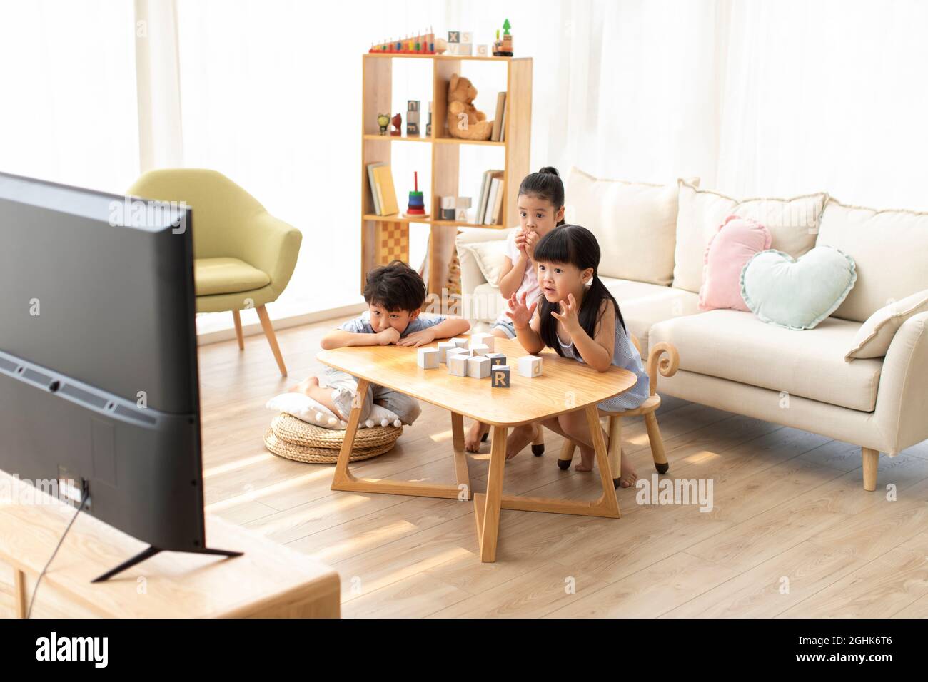 Cute children watching TV in living room Stock Photo - Alamy