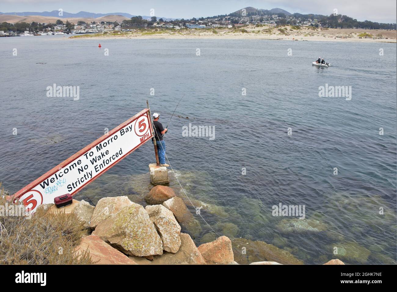 People fishing at the entrance to Morro Bay, with the
