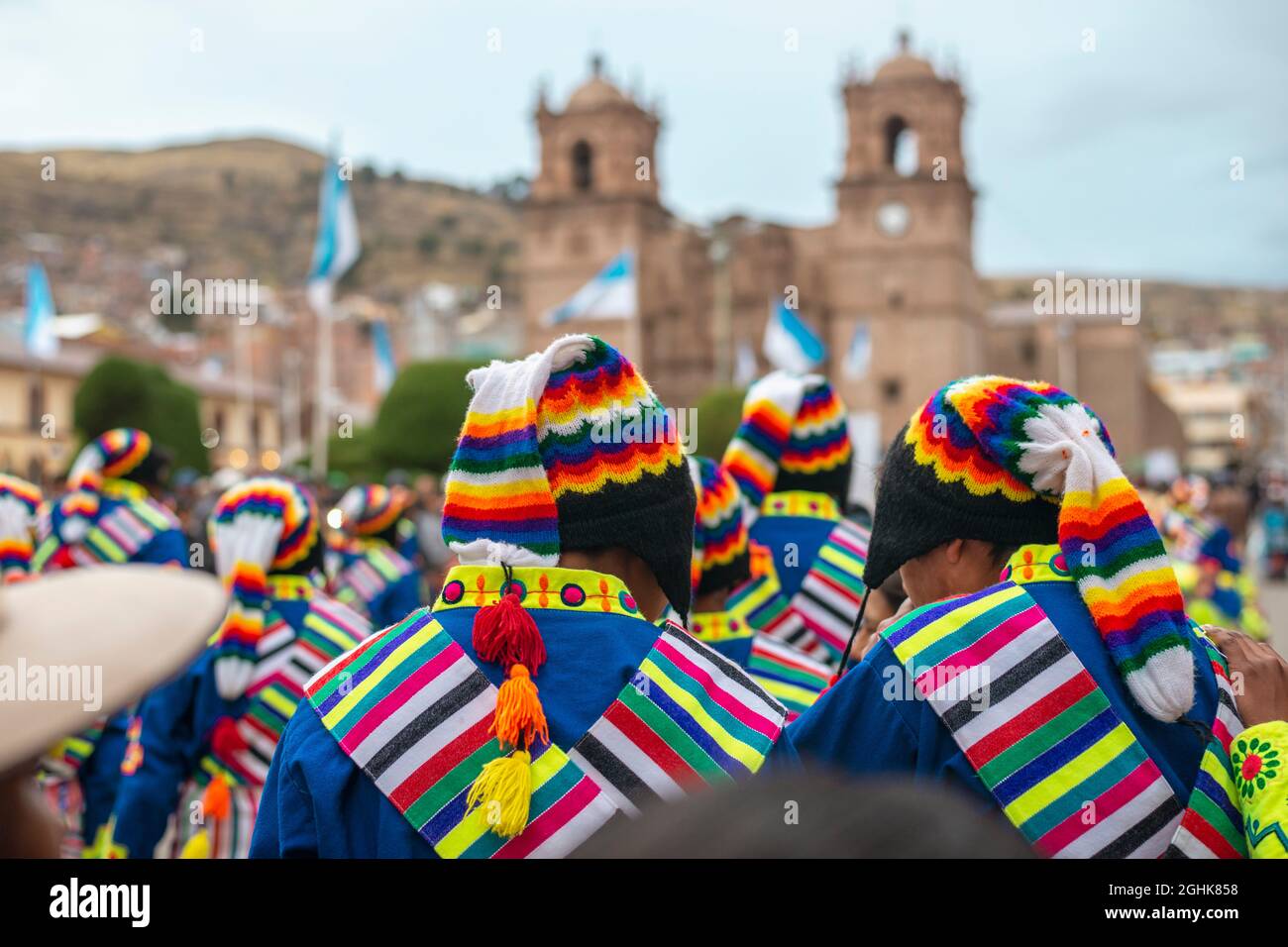 many performers in bright traditional costumes at the main city square in Puno, Peru Stock Photo