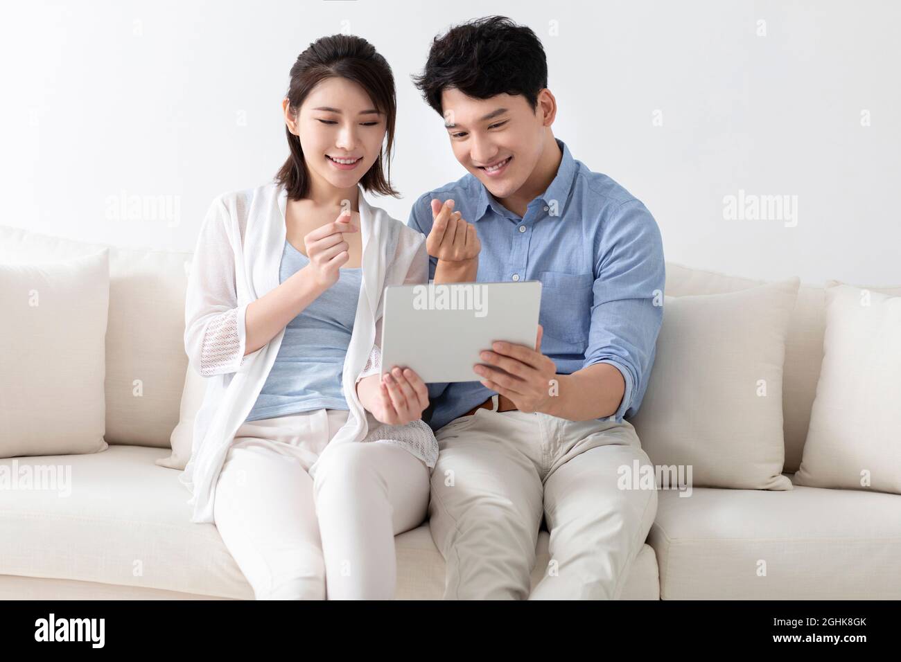 Cheerful young couple using digital tablet Stock Photo