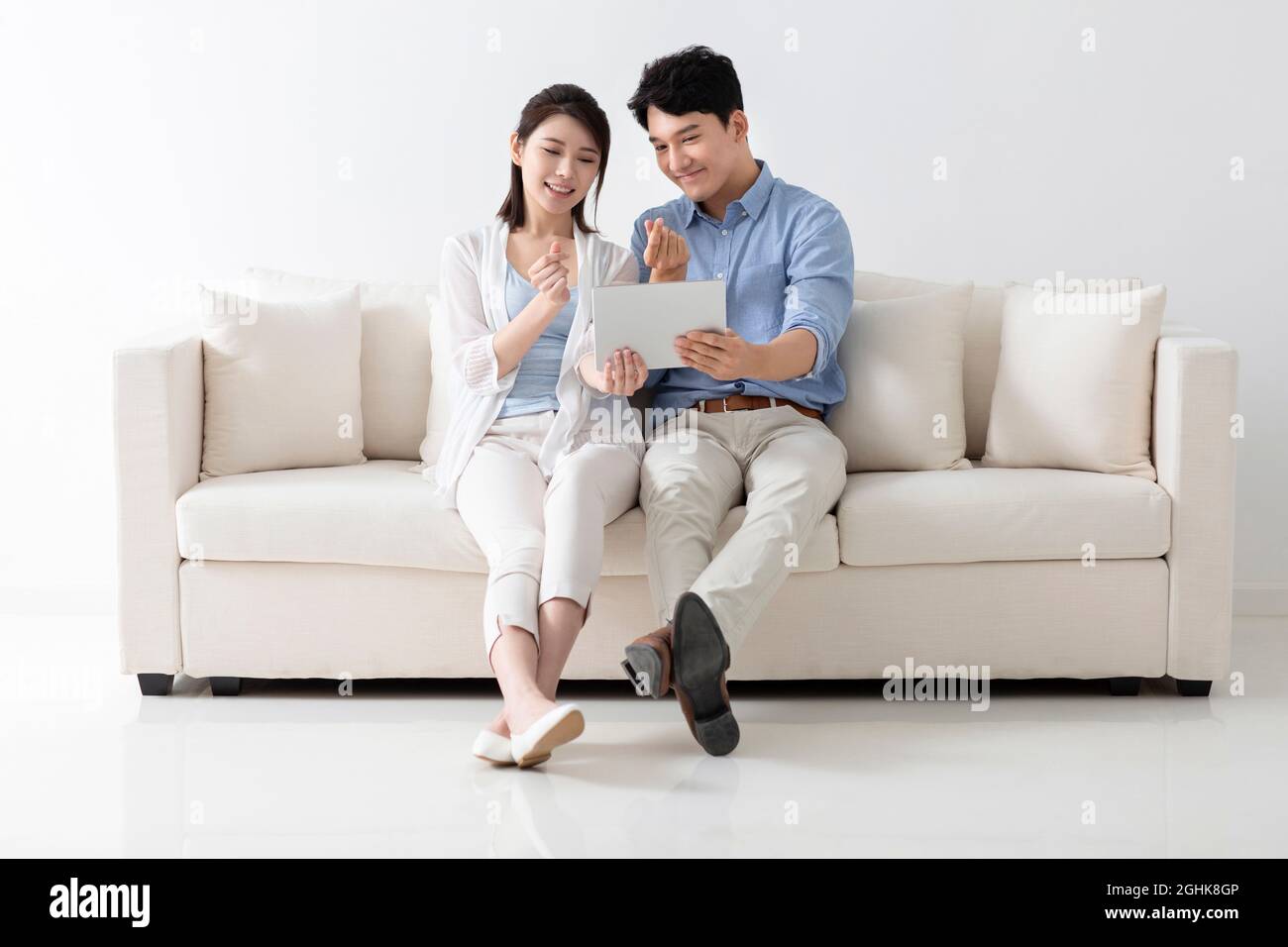 Cheerful young couple using digital tablet Stock Photo