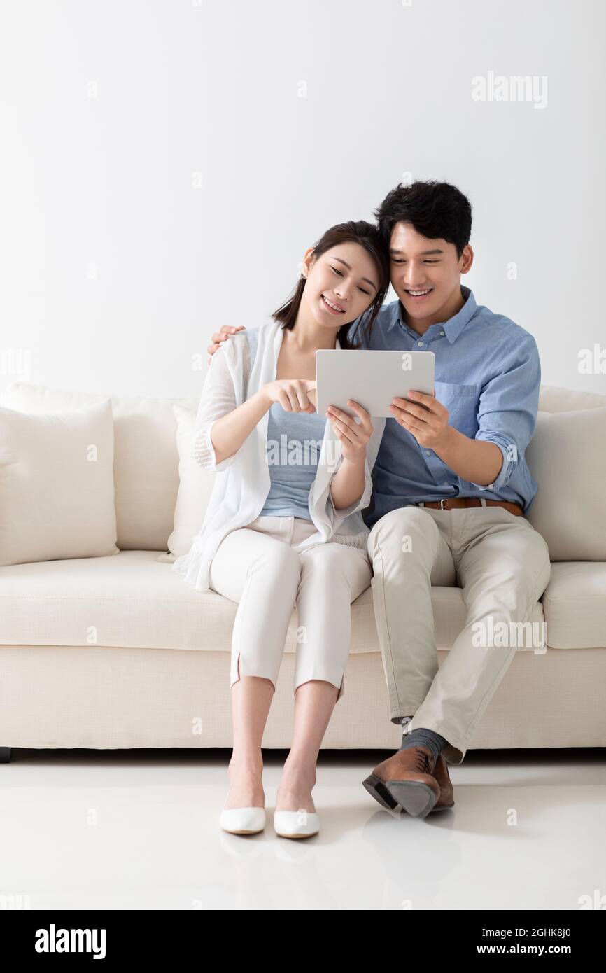 Cheerful young couple using digital tablet Stock Photo