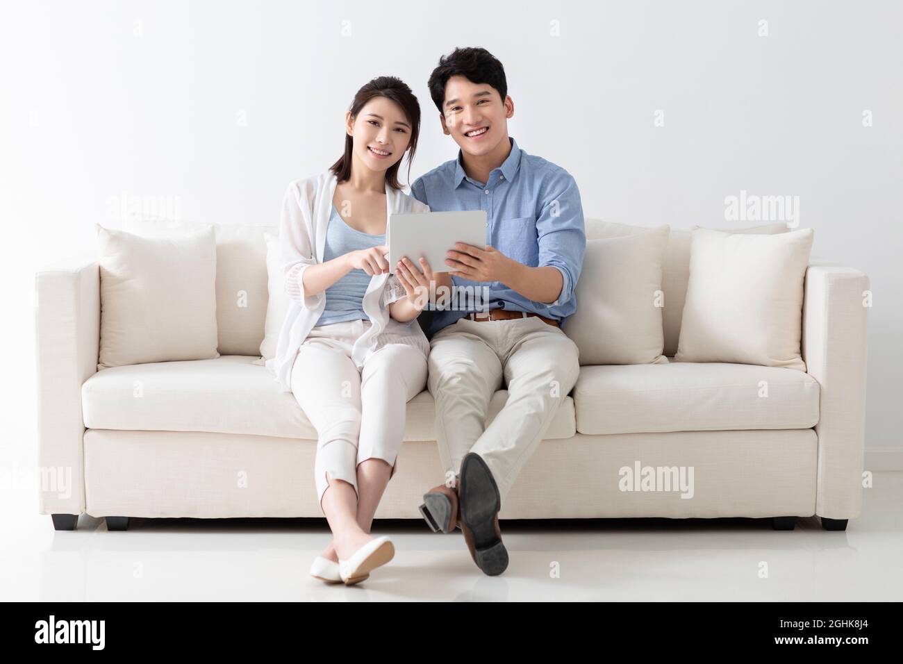Cheerful young couple using digital tablet Stock Photo