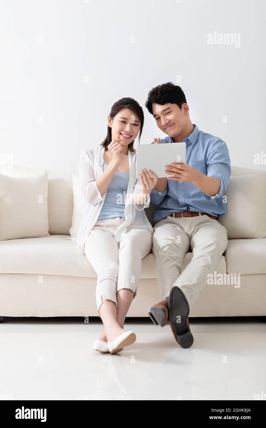 Cheerful young couple using digital tablet Stock Photo