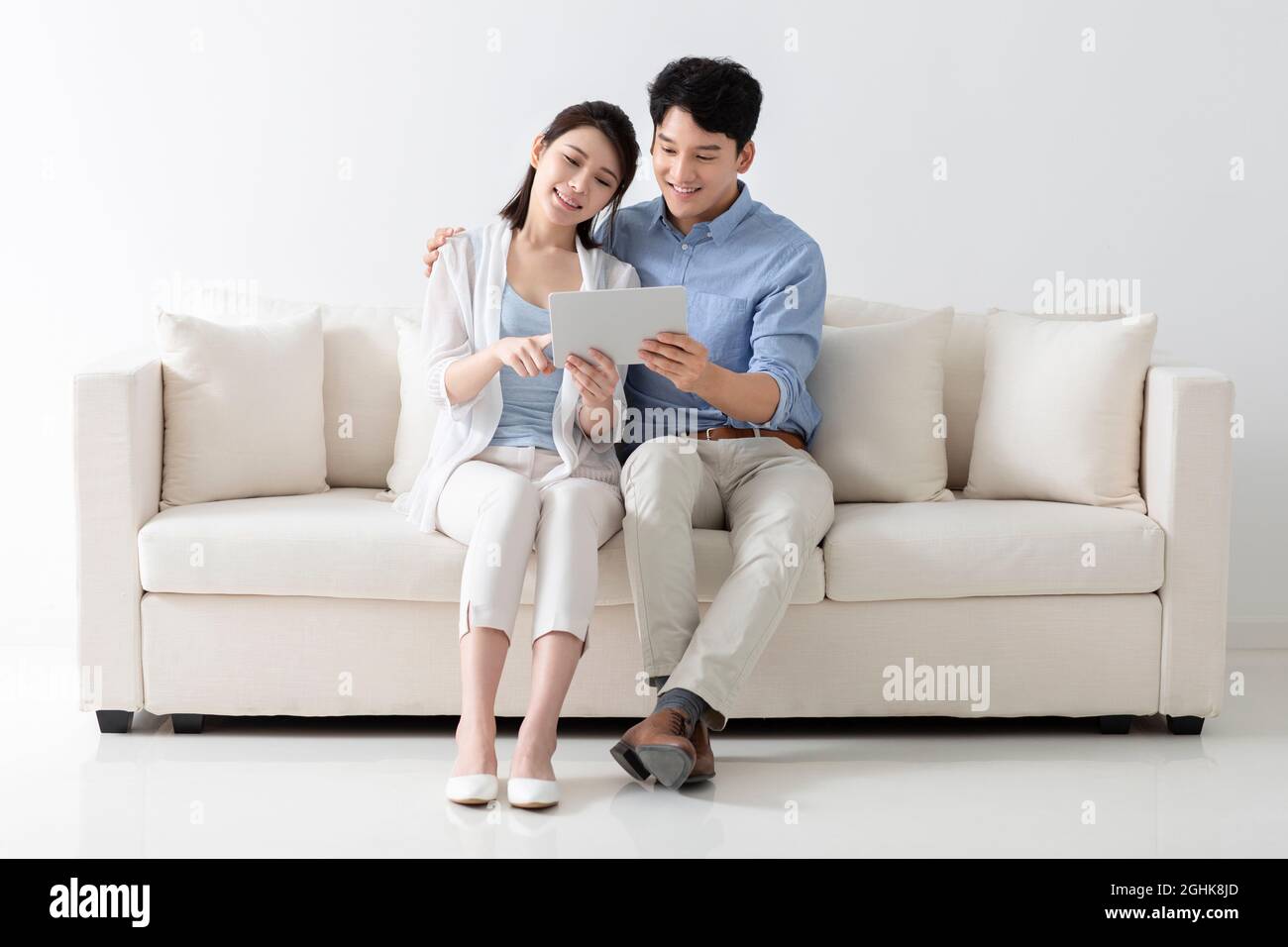 Cheerful young couple using digital tablet Stock Photo