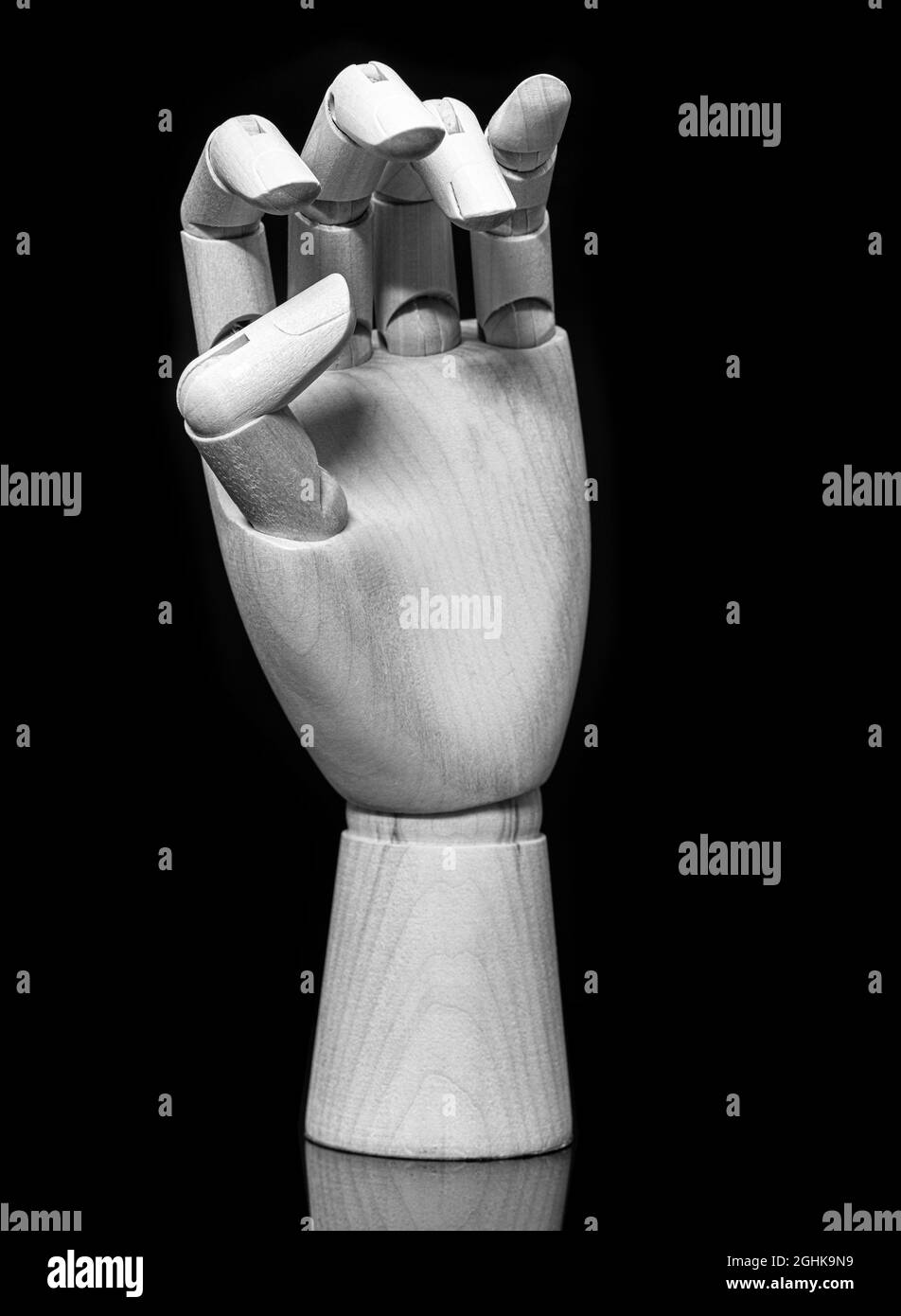 Wooden Hand on a black background Stock Photo