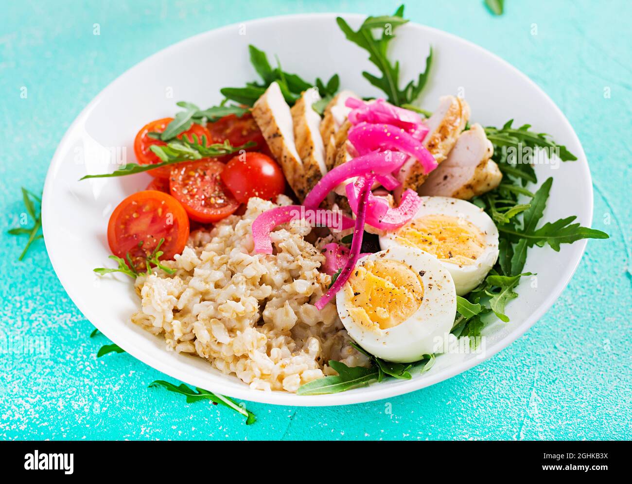 Fillet Breakfast Fresh salad. Breakfast bowl with oatmeal, chicken fillet, tomato, red ...