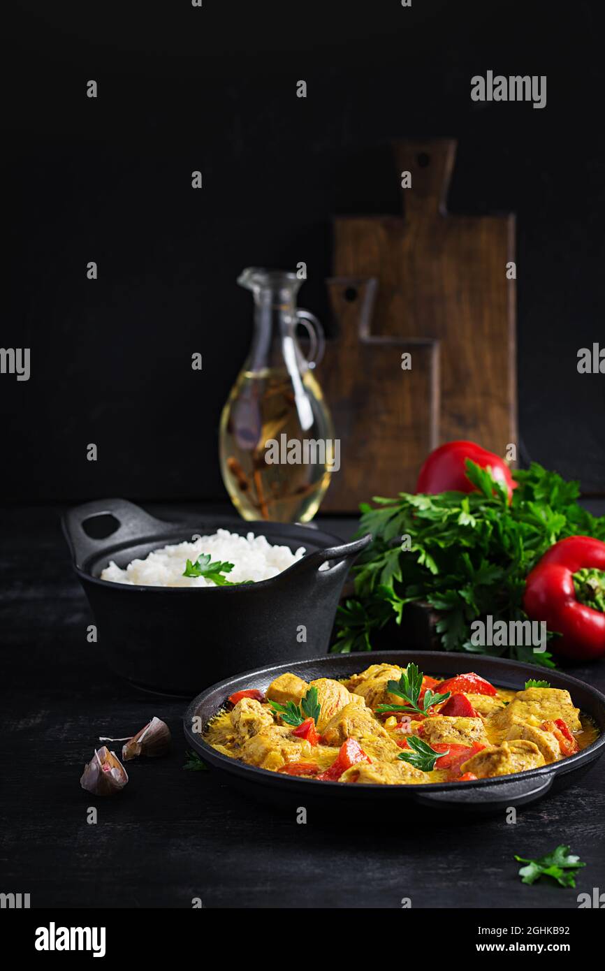 Traditional Indian curry chicken masala. Indian chicken curry with sweet peppers and rice in