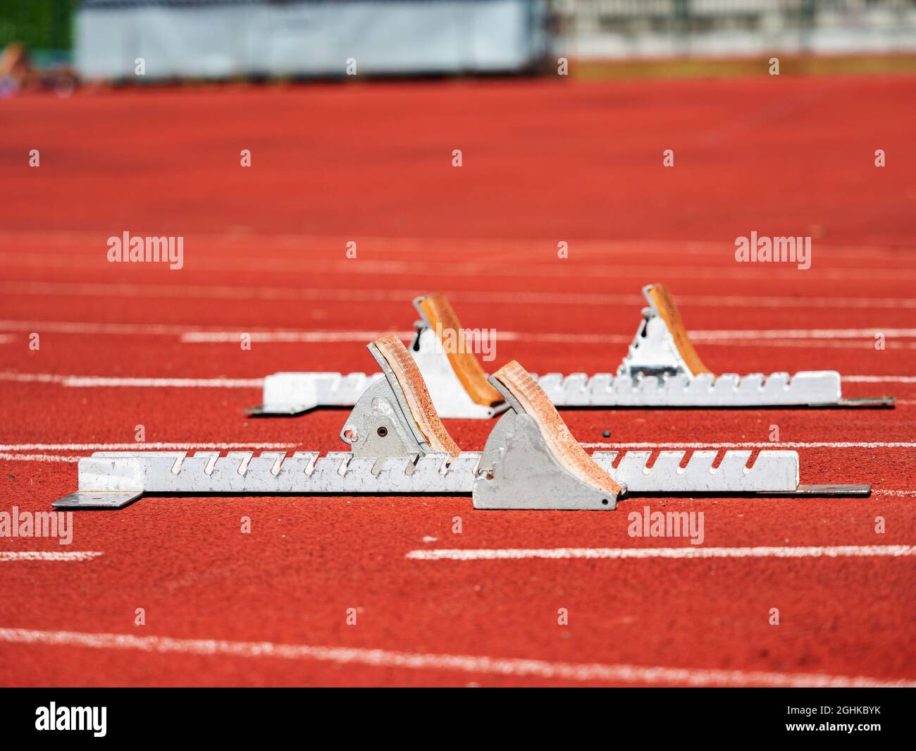 Close view to run start blocks ready on stadium tracks. Metal frame