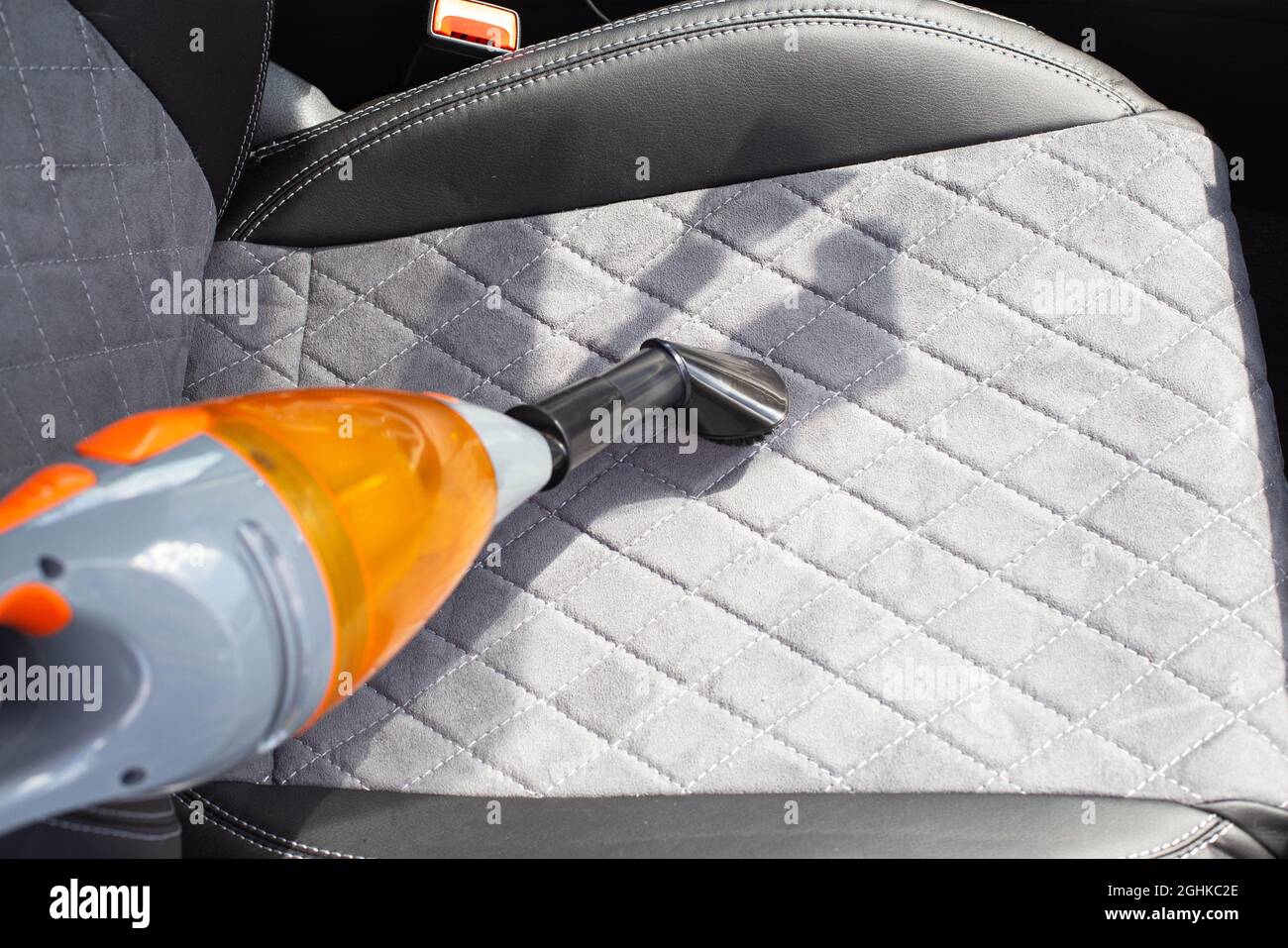 Dry cleaning in the passenger compartment of a car with a car vacuum cleaner from dust and dirt