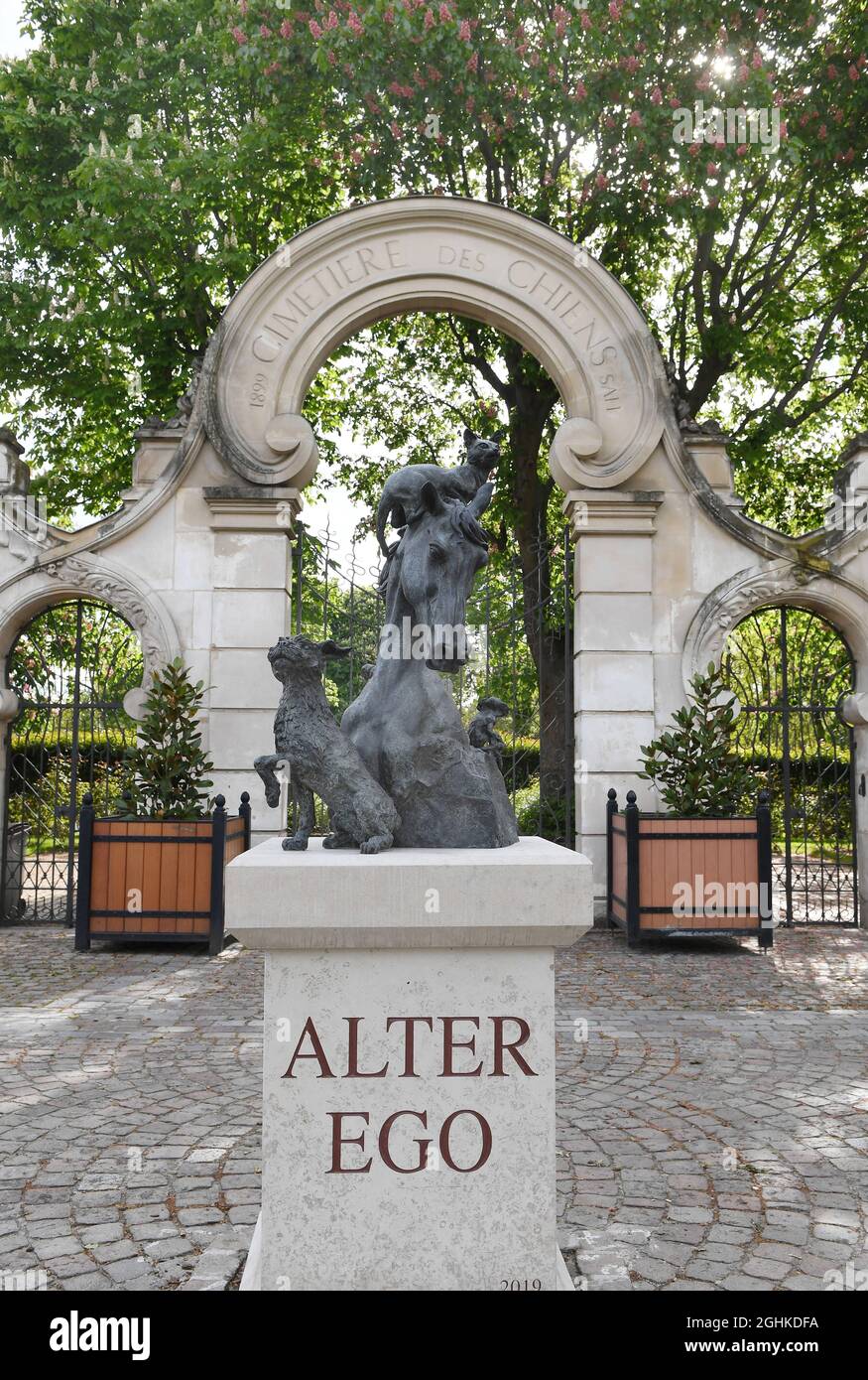 The sculpture 'Alter Ego' by sculptor Arnaud Kasper and the stone entrance  designed by Art Nouveau architect Eugene Petit at the âÂ€Â˜Cimetiere des  ChiensâÂ€Â™ in Asnieres-sur-Seine on the outskirts of Paris, France