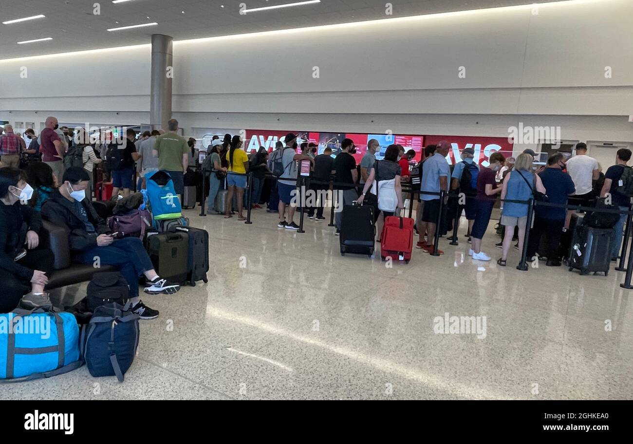 People wait in line at the Avis counter at the Salt Lake City International Airport rental car center amid the global coronavirus COVID-19 pandemic, S Stock Photo