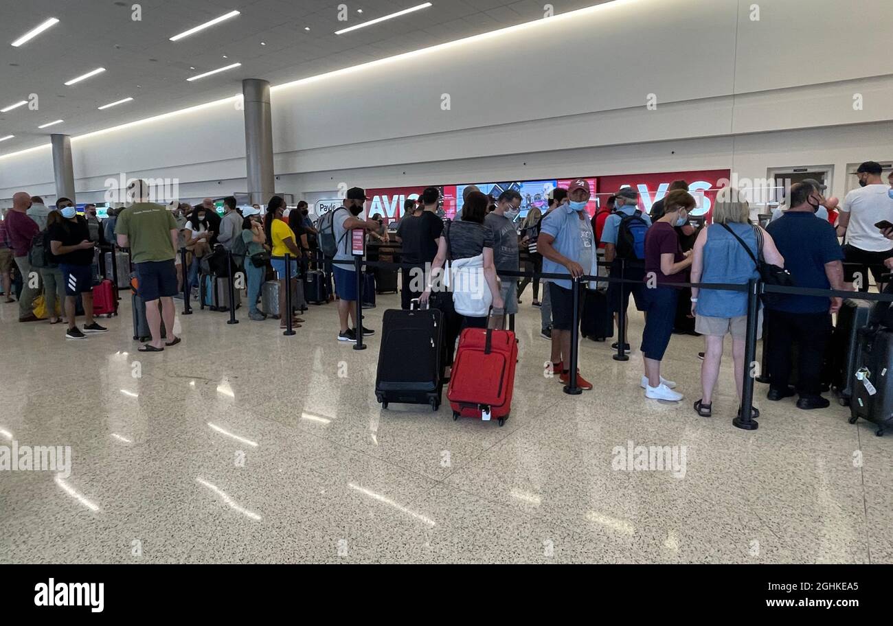 People wait in line at the Avis counter at the Salt Lake City International  Airport rental car center amid the global coronavirus COVID-19 pandemic, S  Stock Photo - Alamy
