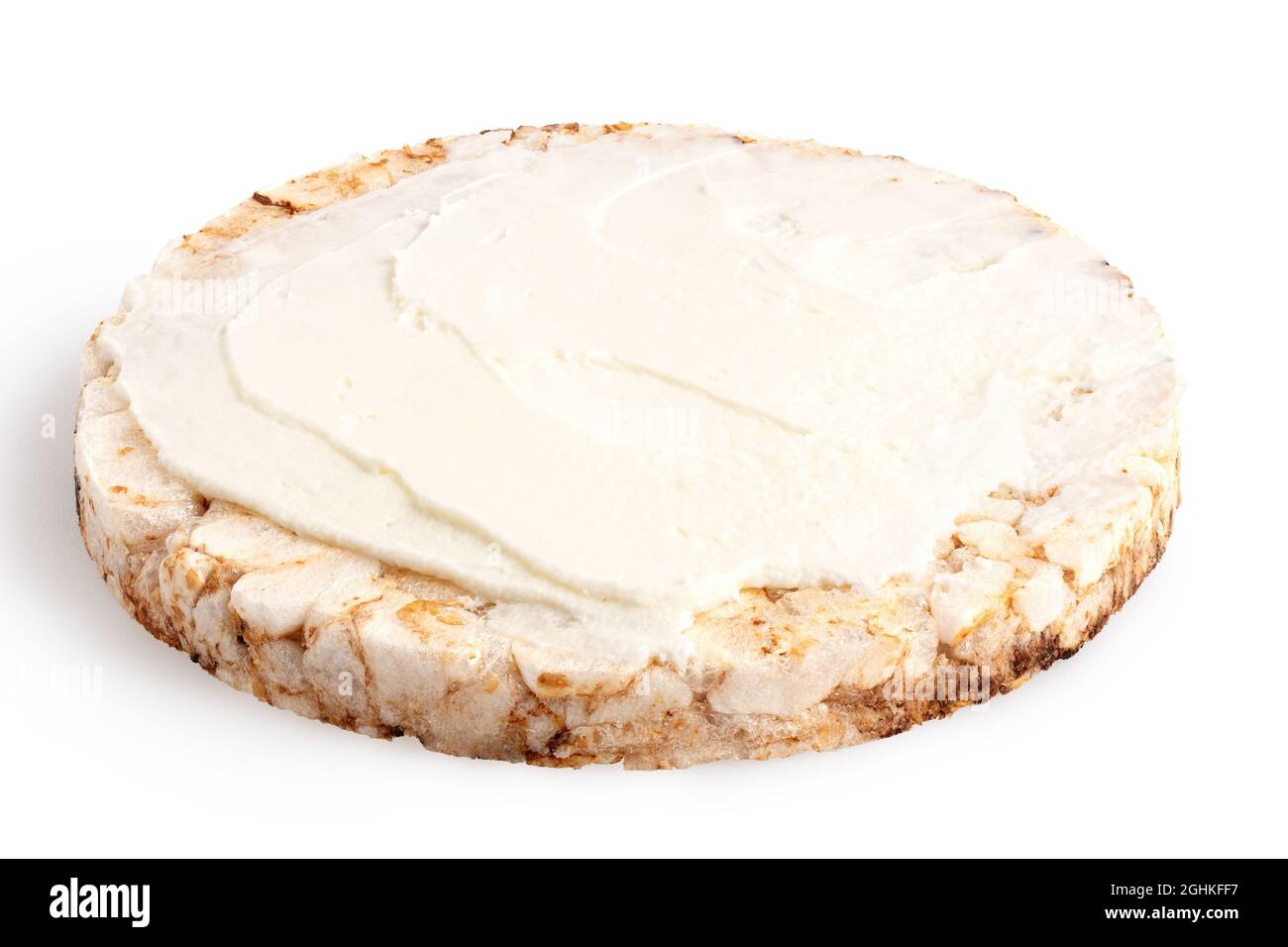 Puffed brown rice cake with cream cheese spread isolated on white. Stock Photo