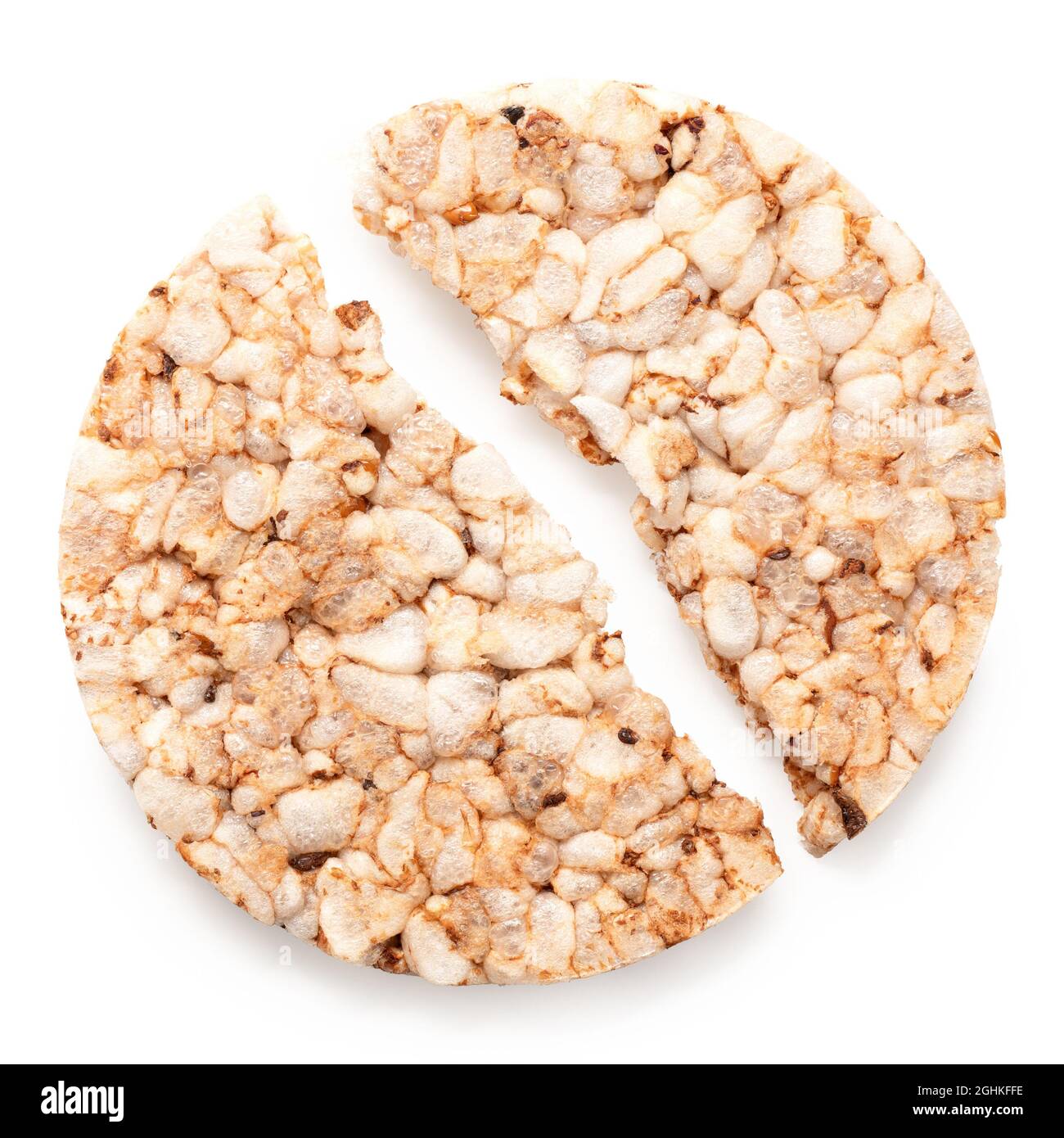 Broken plain puffed brown rice cake isolated on white. Top view. Stock Photo