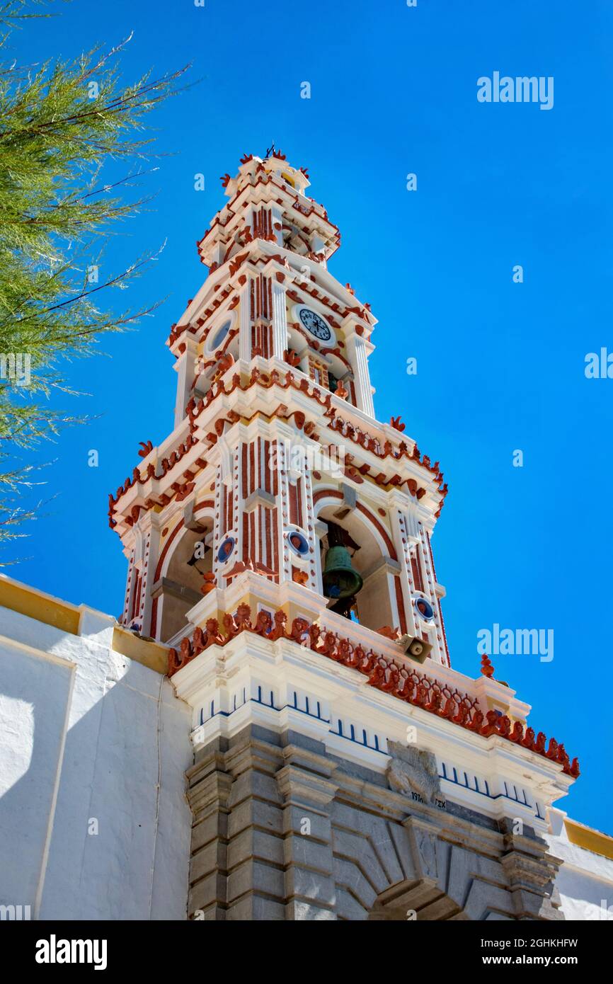 SYMI, Greece - JUN 03, 2021. The church tower of Panormitis Monastery of the Archangel Michael on the island of Symiis one of the tallest Baroque bell Stock Photo