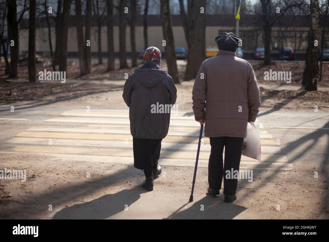 Old woman walking stick crossing hi-res stock photography and images ...