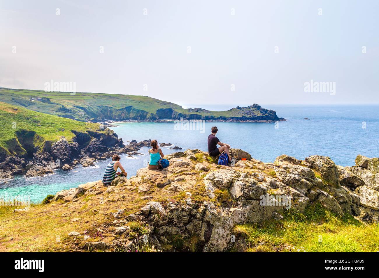 Hikers taking a break at scenic viewpoint of Carnelloe Headland along the South West Coast Path near Zennor, Penwith Peninsula, Cornwall, UK Stock Photo