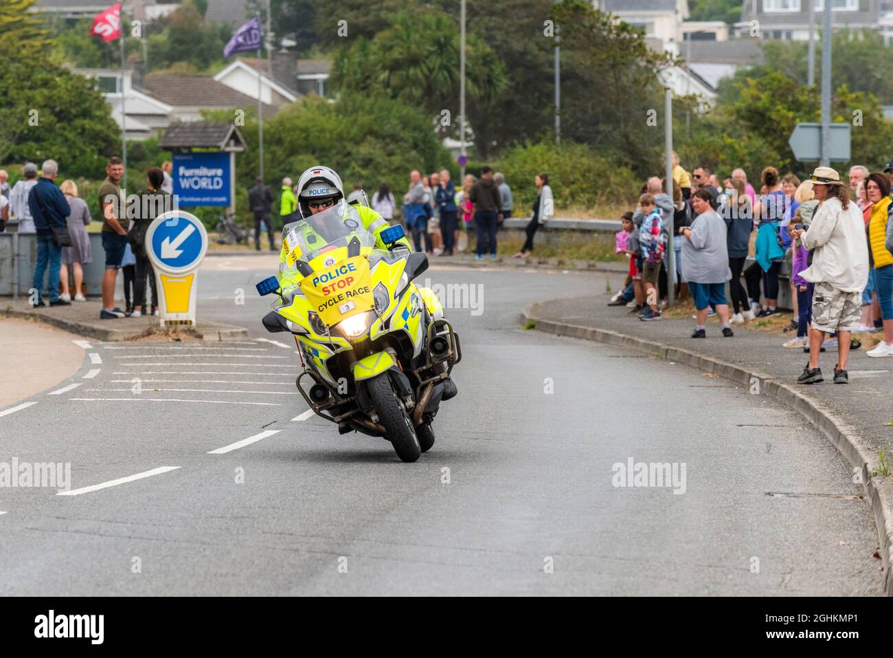 A polic patrol motorcyclist riding into Newquay in Cornwall during the opening stage of the iconic Tour of Britain 2021 - known as The Grand Depart. Stock Photo