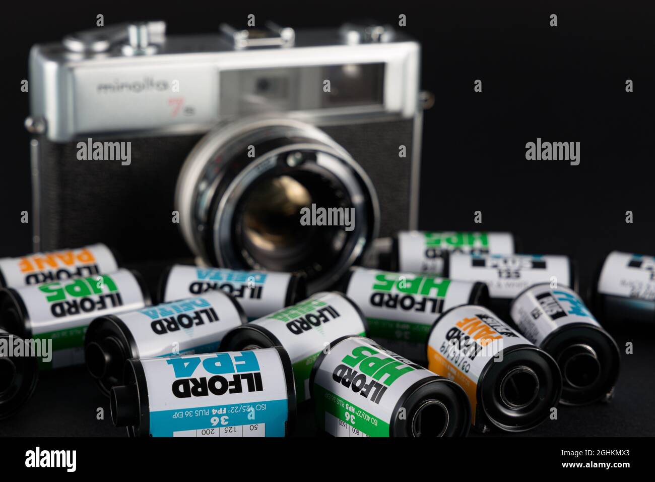 VALENCIA, SPAIN - SEPTEMBER 06, 2021: Black and white 35mm film rolls and old Minolta rangefinder camera. Film photography return concept Stock Photo