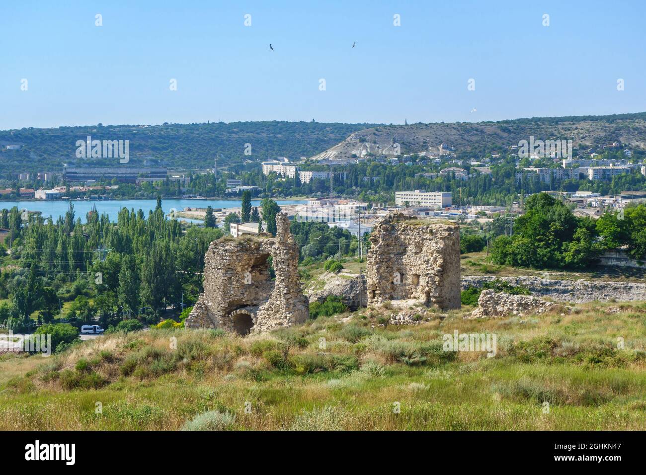 Panorama of medieval towers of Kalamita, fortress founded by Byzantines. It was built above cliff hiding cave church of St Clement. Modern city Inkerm Stock Photo