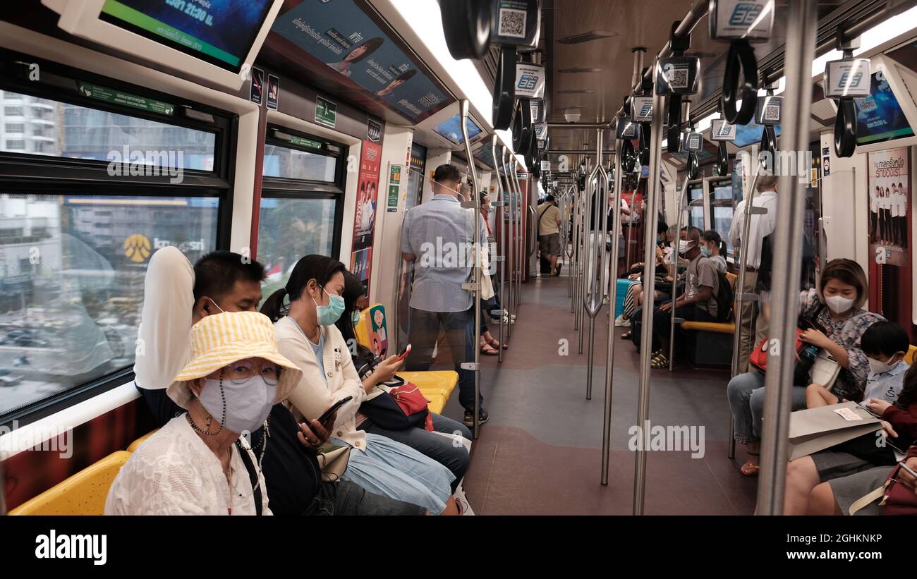 Inside BTS Skytrain Coach During Pandemic People Wearing Face Mask Stock Photo