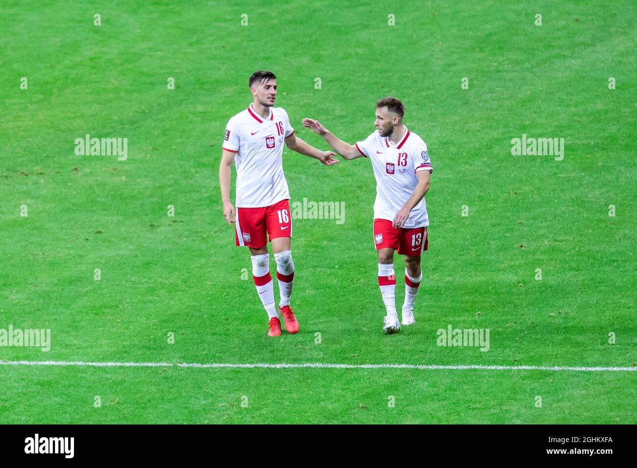 Jakub Moder (L) and Maciej Rybus (R) of Poland in action during the FIFA World Cup 2022 Qatar qualifying match between Poland and Albania at PGE Narodowy Stadium. (Final score; Poland 4:1 Albania) Stock Photo