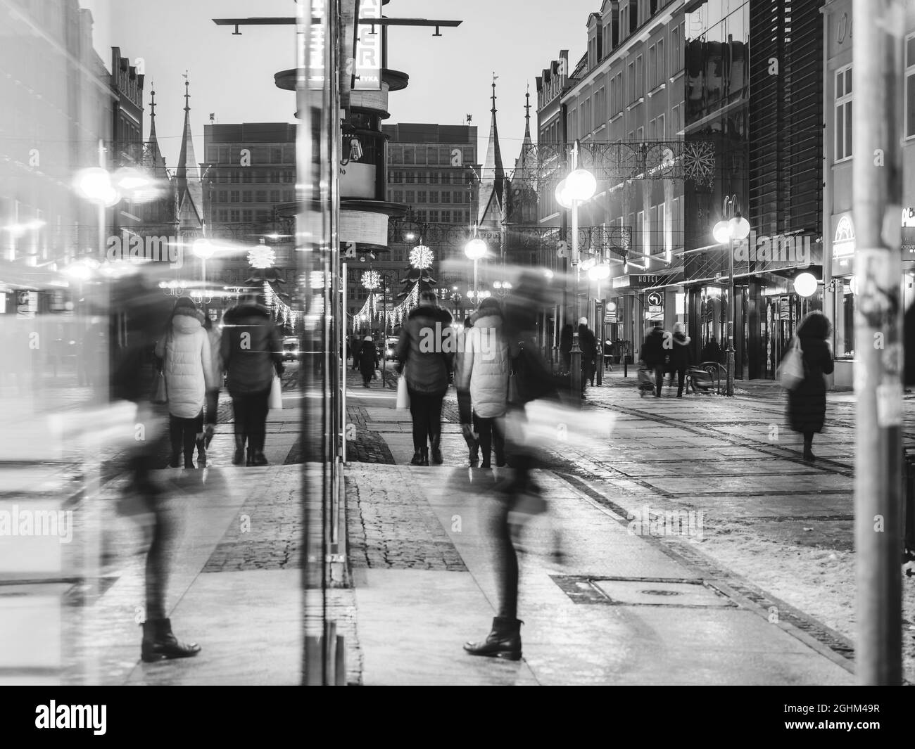 Urban environment, people walking in the city center at night Stock Photo